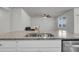 Elegant kitchen island with double sinks, granite countertop, and a view of the living area at 259 N Light Way, Summerville, SC 29486