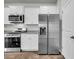 Well-lit kitchen featuring stainless steel appliances and white cabinetry at 259 N Light Way, Summerville, SC 29486