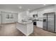 Bright, modern kitchen features stainless steel appliances, granite counters, and a large island at 259 N Light Way, Summerville, SC 29486
