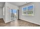 Bright room with wood floor, large windows, and sliding glass door at 259 N Light Way, Summerville, SC 29486