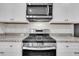 Close up of a modern kitchen with stainless steel stove and white cabinets at 259 N Light Way, Summerville, SC 29486