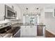 Bright kitchen with stainless appliances, granite counters, and an open layout to the dining area at 270 Stefan Dr # 11-C, Charleston, SC 29412