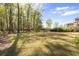 Expansive backyard with mature trees and lush lawn, perfect for outdoor activities and privacy at 2912 Yachtsman Dr, Mount Pleasant, SC 29466