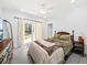 Cozy bedroom with a ceiling fan, a sliding glass door to the yard, and neutral decor at 2912 Yachtsman Dr, Mount Pleasant, SC 29466