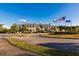 Impressive clubhouse with manicured landscaping, American flags, and circular driveway entrance at 2912 Yachtsman Dr, Mount Pleasant, SC 29466