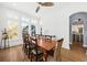 Bright dining room with hardwood floors, ceiling fan, large windows and view to another room at 2912 Yachtsman Dr, Mount Pleasant, SC 29466