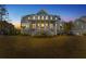 Beautiful multi-story home with outdoor lighting, balconies and large front yard at 2912 Yachtsman Dr, Mount Pleasant, SC 29466