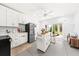 Well-lit kitchen featuring an island, stainless steel refrigerator, and a sliding glass door to the backyard at 2912 Yachtsman Dr, Mount Pleasant, SC 29466