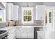 Bright kitchen with white cabinets, tile backsplash, stainless steel appliances, and natural light at 2912 Yachtsman Dr, Mount Pleasant, SC 29466
