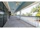 Spacious covered porch featuring black-framed glass doors, white railings, and a light blue ceiling with fans at 2912 Yachtsman Dr, Mount Pleasant, SC 29466