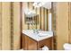 Bathroom with decorative wallpaper, vanity with sink, framed mirror and bright lighting at 303 Pine Bluff Dr, Summerville, SC 29483
