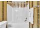 Full bathtub and shower with decorative wallpaper and towel rack at 303 Pine Bluff Dr, Summerville, SC 29483
