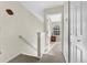 Hallway featuring a carpeted floor and a staircase with white walls and a view into another room with a window at 303 Pine Bluff Dr, Summerville, SC 29483