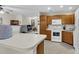 Well-lit kitchen featuring wooden cabinets, white appliances, and neutral countertops at 303 Pine Bluff Dr, Summerville, SC 29483