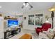 Carpeted living room with a ceiling fan and a partial view of the dining area at 303 Pine Bluff Dr, Summerville, SC 29483