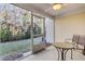 A cozy screened porch with outdoor seating offers a relaxing view of the private backyard and wooded area at 303 Pine Bluff Dr, Summerville, SC 29483