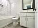 Modern bathroom with sleek white subway tile, a stylish vanity, and contemporary fixtures combines elegance and functionality at 310 Woodland Shores Rd, Charleston, SC 29412