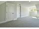 Bright bedroom features plush carpet, double closets, and a window for a calming and organized space at 310 Woodland Shores Rd, Charleston, SC 29412
