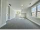 Sunlit bedroom with neutral carpet, double windows, and a view creates a serene retreat at 310 Woodland Shores Rd, Charleston, SC 29412