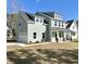 Beautiful two-story home boasting an attached garage, a covered front porch, and professional landscaping at 310 Woodland Shores Rd, Charleston, SC 29412