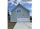 A spacious garage with an overhead light boasts ample space for vehicles and storage at 310 Woodland Shores Rd, Charleston, SC 29412