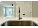 Kitchen island sink featuring chrome fixtures and quartz countertop at 310 Woodland Shores Rd, Charleston, SC 29412