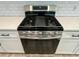 Stainless steel gas range cooktop with oven and white cabinets and drawers with stainless steel pulls at 310 Woodland Shores Rd, Charleston, SC 29412