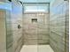 Gorgeous glass enclosed shower with gray tile and a built-in shower niche at 310 Woodland Shores Rd, Charleston, SC 29412