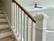 Bright staircase featuring wood treads, white risers, and a natural wood handrail complements the open-concept living space at 310 Woodland Shores Rd, Charleston, SC 29412