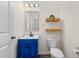 Stylish bathroom with a blue vanity, modern fixtures, decorative shelves and neutral paint at 342 Saxony Loop, Summerville, SC 29486