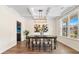 Elegant dining room with coffered ceilings, wood-look floors, and stylish light fixture and a large window at 342 Saxony Loop, Summerville, SC 29486