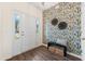 Charming entryway featuring unique wallpaper, wood-look floors, and a bench for added convenience at 342 Saxony Loop, Summerville, SC 29486
