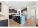 Modern kitchen boasts granite countertops, an island with blue accents, and stainless steel appliances at 342 Saxony Loop, Summerville, SC 29486
