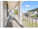 Relaxing covered porch overlooking the lush front yard and neighborhood at 342 Saxony Loop, Summerville, SC 29486