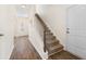 Hallway featuring carpeted stairs and a wooden banister with a convenient coat closet at 342 Saxony Loop, Summerville, SC 29486