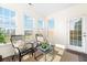 Bright sunroom featuring wicker chairs, an area rug and a glass door to the backyard at 342 Saxony Loop, Summerville, SC 29486