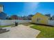 This backyard has a concrete patio, a white fence, and a grill ready for outdoor entertaining at 401 Forsythia Ave, Summerville, SC 29483