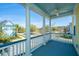 Charming balcony with white columns overlooking a beautiful neighborhood and pond, perfect for relaxing outdoors at 401 Forsythia Ave, Summerville, SC 29483
