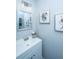Cozy bathroom with a white vanity, elegant mirror, and decorative floral art, creating a tranquil space at 401 Forsythia Ave, Summerville, SC 29483
