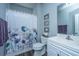 Bathroom with blue walls, a shower curtain with flowers, and white cabinets at 401 Forsythia Ave, Summerville, SC 29483
