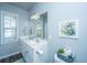 Bright bathroom with large mirror, vanity, and natural light from the window at 401 Forsythia Ave, Summerville, SC 29483