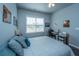 Bedroom with a bed and a computer desk with white walls and a ceiling fan at 401 Forsythia Ave, Summerville, SC 29483