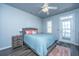 Serene bedroom featuring a queen-sized bed, ceiling fan, and access to a balcony, providing a tranquil retreat at 401 Forsythia Ave, Summerville, SC 29483
