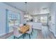 Cozy dining area with wood table, stylish lighting, and bright windows showcasing a comfortable and inviting space at 401 Forsythia Ave, Summerville, SC 29483