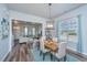 Open dining area with modern lighting, a wooden table, and seamless flow into the living room at 401 Forsythia Ave, Summerville, SC 29483