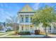 Charming yellow two-story home with a welcoming front porch and well-manicured landscaping at 401 Forsythia Ave, Summerville, SC 29483
