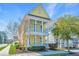 Attractive two-story yellow home featuring a double front porch and beautifully landscaped front yard at 401 Forsythia Ave, Summerville, SC 29483
