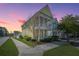 This charming two-story home boasts a beautifully landscaped yard, and inviting double porches at 401 Forsythia Ave, Summerville, SC 29483