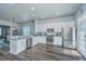 Modern kitchen featuring white cabinets, stainless steel appliances, gray countertop and dark wood-style flooring at 401 Forsythia Ave, Summerville, SC 29483