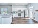 Bright kitchen with white cabinets, stainless steel appliances, a breakfast bar, and access to the backyard at 401 Forsythia Ave, Summerville, SC 29483
